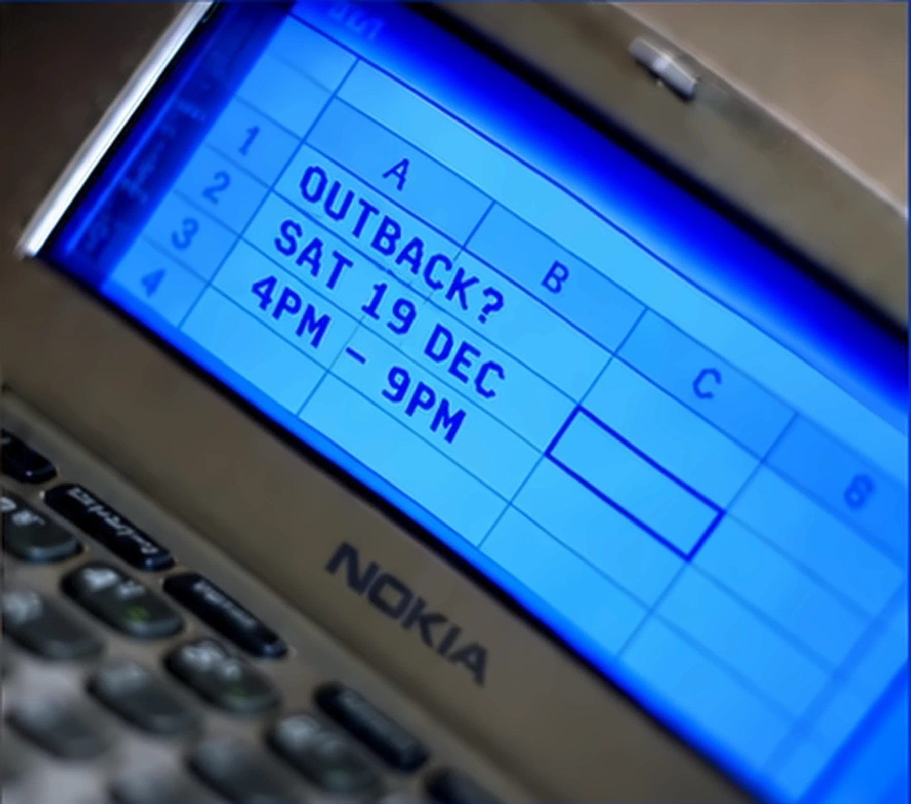 A Nokia communicator showing a spreadsheet: OUTBACK? SAT 19 DEC 4PM – 9PM